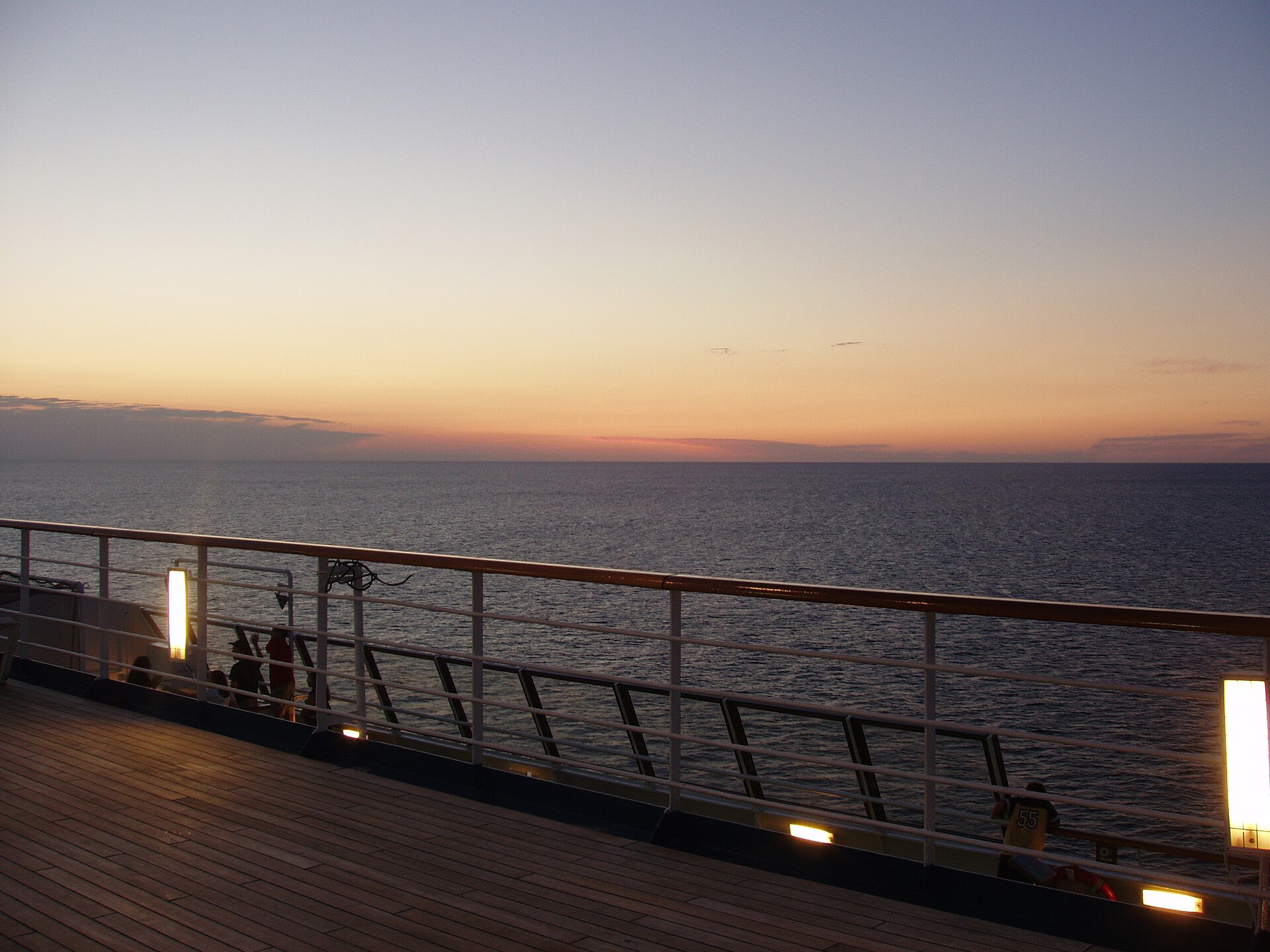 Cruise ship sailing across open ocean at golden hour